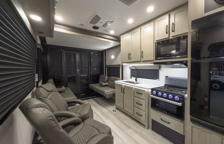 Living area looking back towards garage with patio doors
