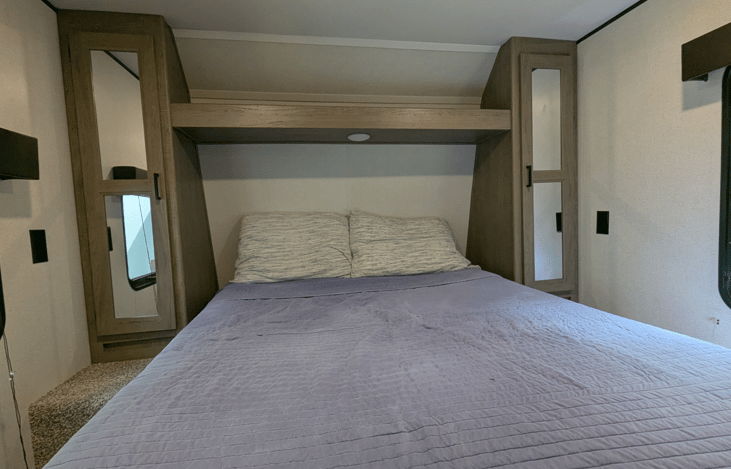 Cozy Queen bed with ample storage in the private bedroom.