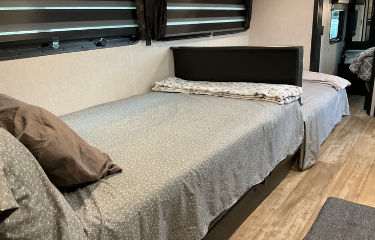 Dinette area and jackknife sofa area made into beds.