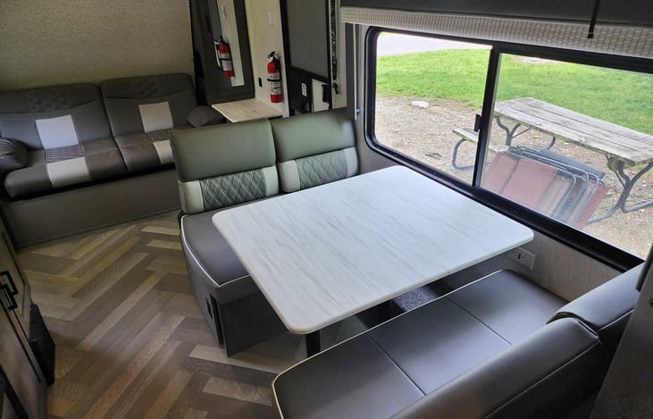 The dinette is in front of a huge camp side window.