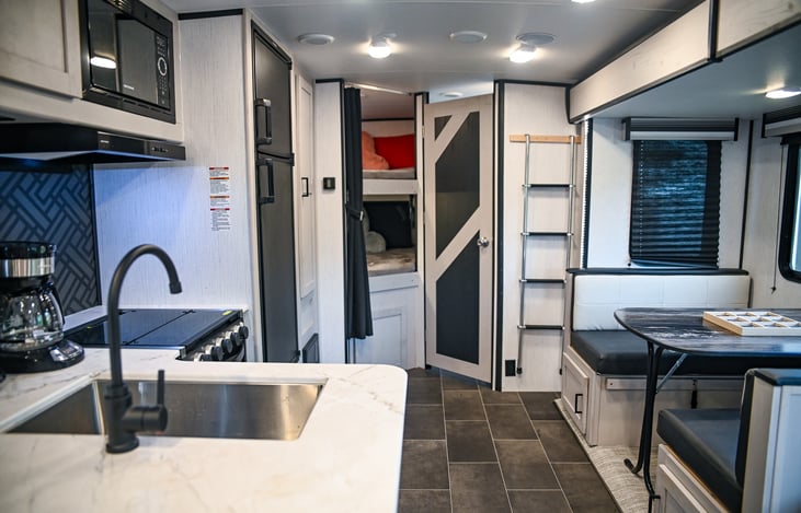 A welcoming view towards the cozy bunk rooms and bathroom—ideal for families or groups ready to enjoy a comfortable stay with all the amenities you need.