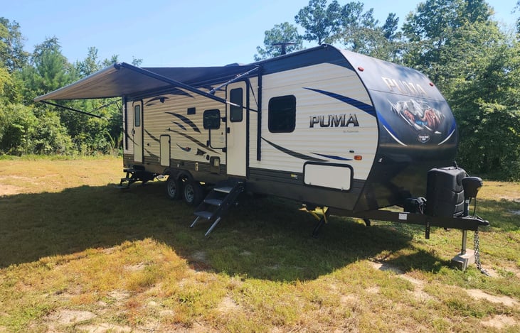 Extended canopy, outside fridge, comfortable chairs and portable grill located in the storage compartment.