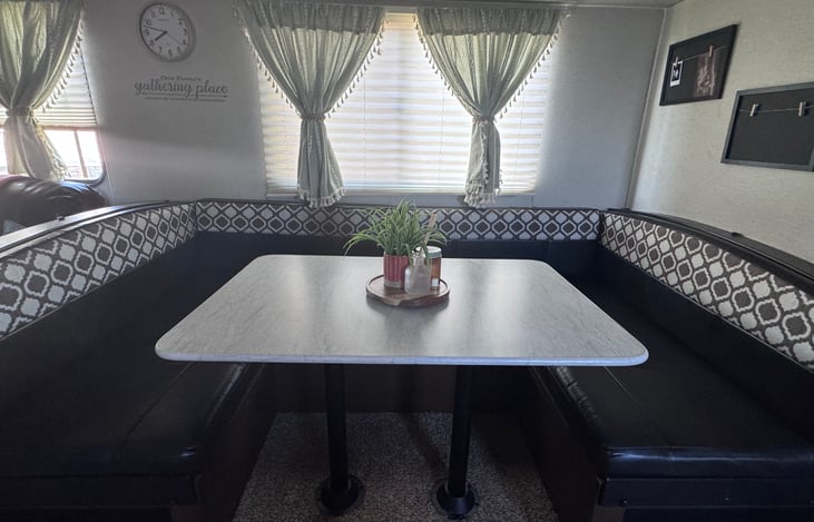 U shaped dinette that converters to sleeper with memory foam topper stored under bench.