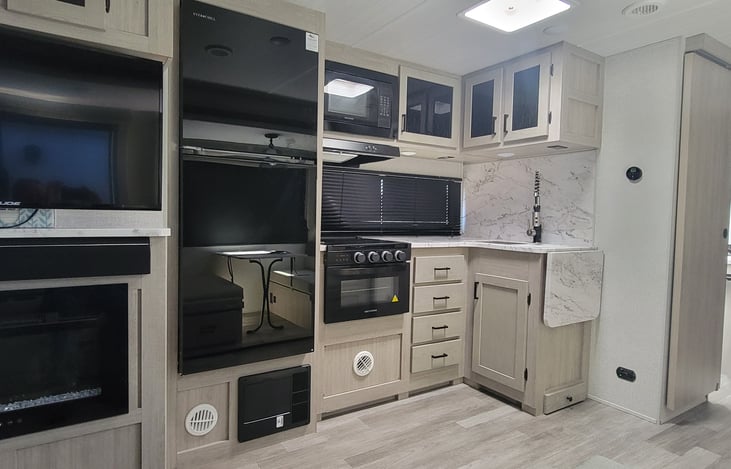 Large 12v fridge with three burner stove, digital oven and microwave. All dishes, utensils and cleaning supplies included in your camping experience.