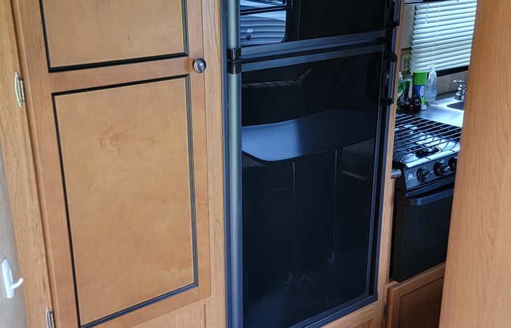 Mid size refrigerator with side pantry