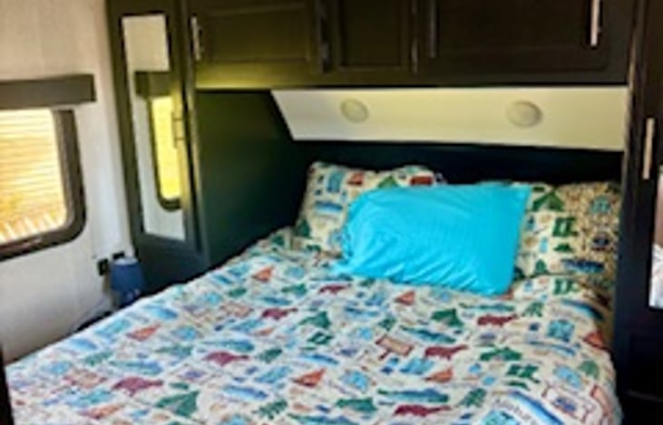 Walk-around Camper Queen with 2 mattress toppers to ensure a restful night.