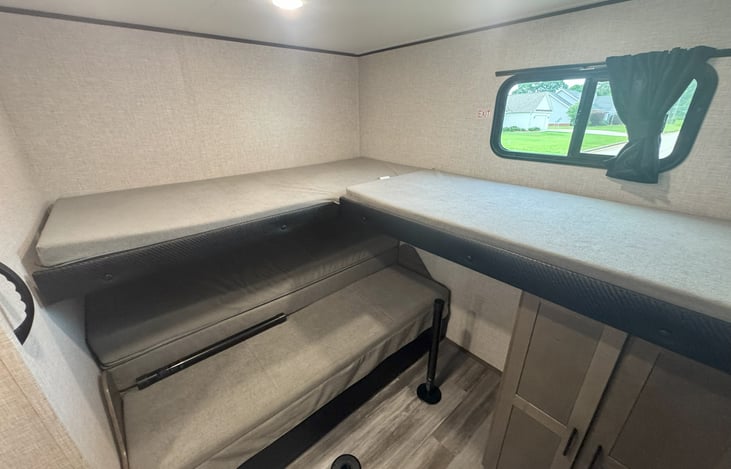 Bunk room with two bunks and one RV queen sleeper sofa