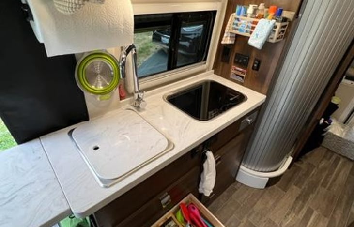 Corian countertops, with propane two burner stove.