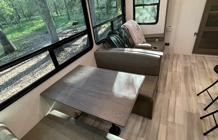 Dinette with storage under the seats + it folds down into another bed!