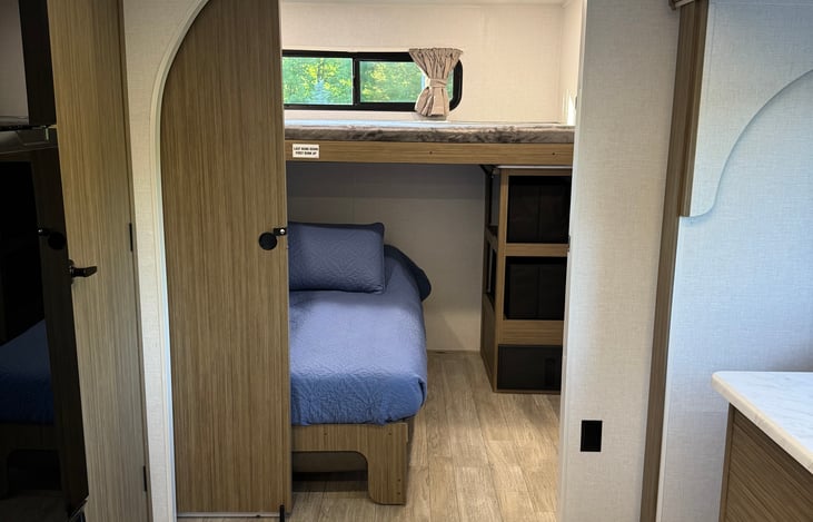 Private bunk house with queen bed (linens provided) and two upper bunks.