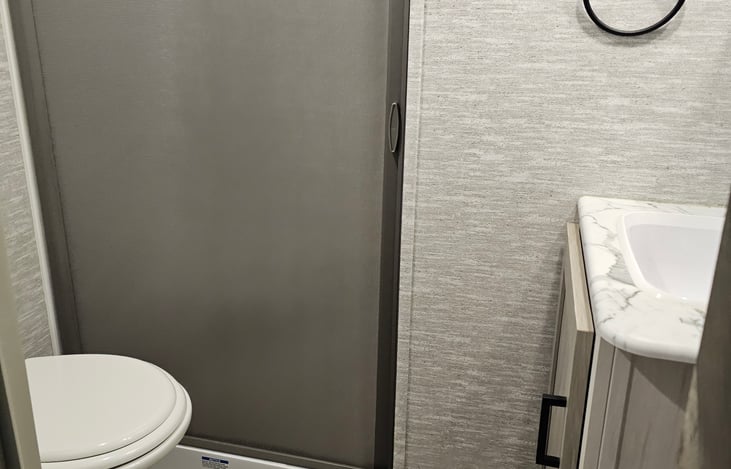 Bathroom has a stand in shower. It is very roomy.