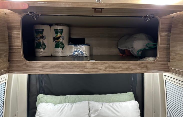 Huge cabinet above bed.