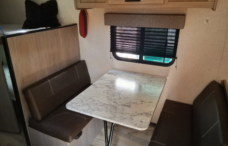 Cozy kitchen table that can be taken outside for extra table space or the table can be coverted into a day bed for 2. Also there is a hammock hanging if you find the perfect spot to nap!