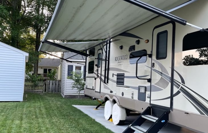 Double entry doors, two power awnings, sturdy entry steps with assist bars and screen door on both sides. Also has an outside grill and the TV from master bedroom attaches to the side of the camper.