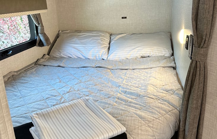 Bunk bed with sheets, pillows, throw and blanket for your comfort