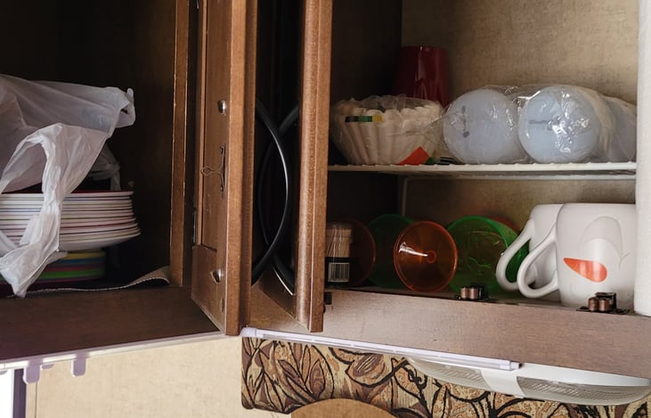 Kitchen cupboards with dishes, cups, etc