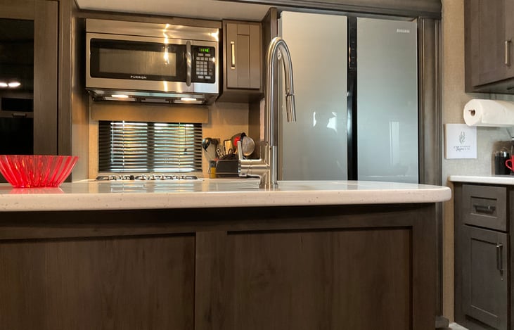 Window over the stove, this RV has a huge 16’ residential type fridge.