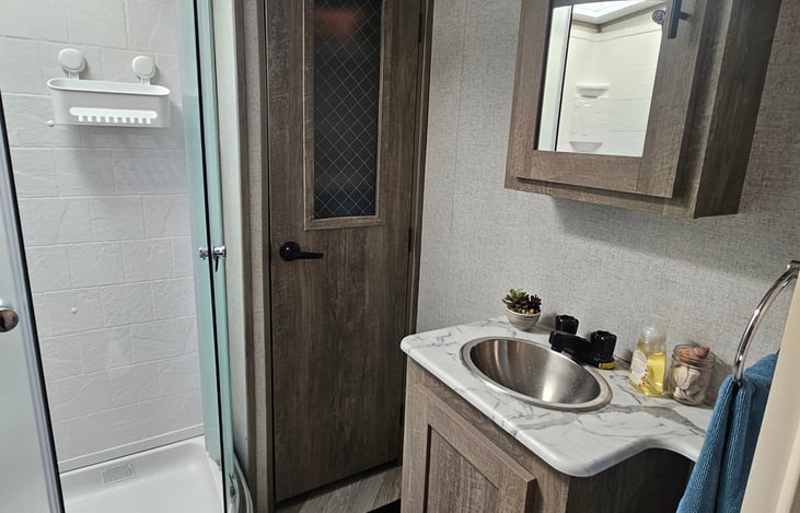 Bathroom with shower and linen closet