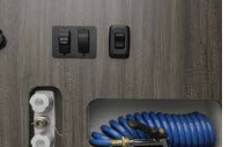 Close up of spray station. This will allow you to clean your gear. The far right switch turns on the pump. Other two switches are for external lights.