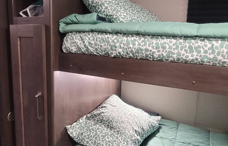 Bunk house has 4 beds, 4 large drawers, 2 small drawers, shoe cubby, and a small closet with hanging space.