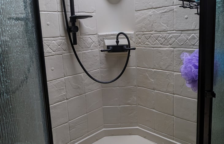 Stand-up shower with removable shower head and sky-light.