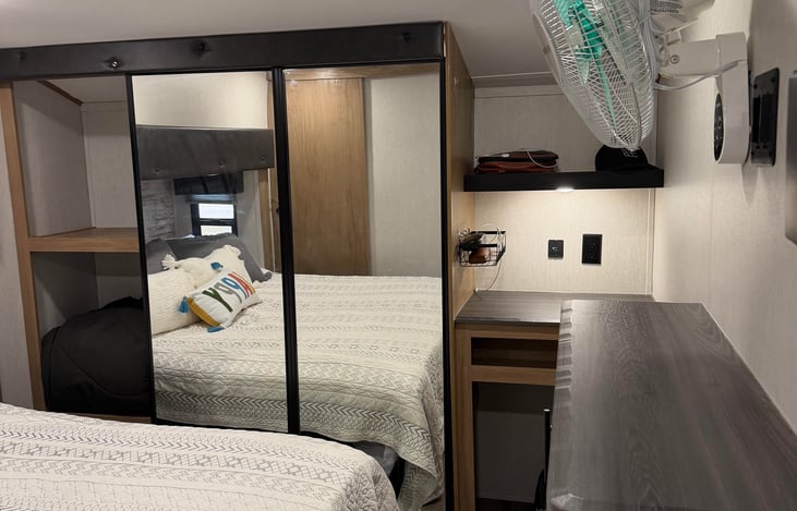 King-sized bed located in the quiet upper deck of the fifth wheel. Designed to provide plenty of walk-around space on both sides of the bed.