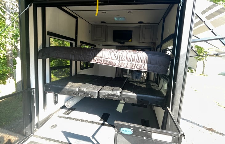 Top bed goes up to the ceiling on a motorized track.  Bottom bed converts to couches or stores away up the track as well!