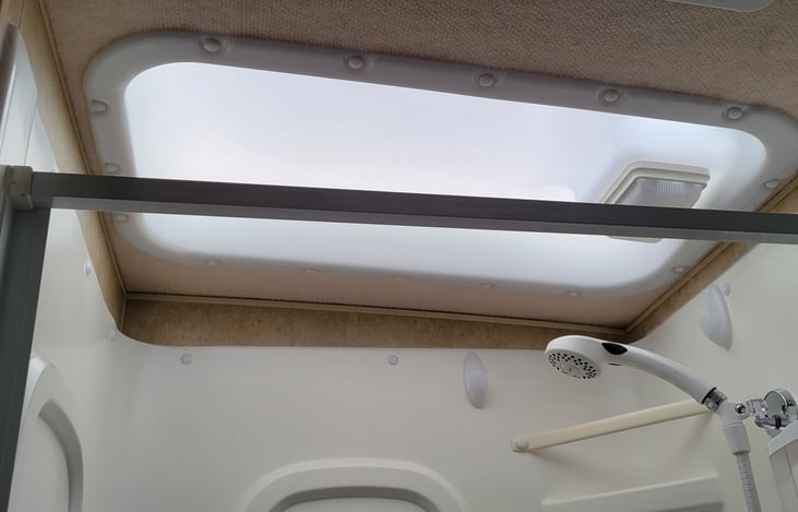 Skylight over shower for extra height and brightness 🌞