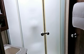 Large RV with outdoor kitchen, fireplace, and TVs