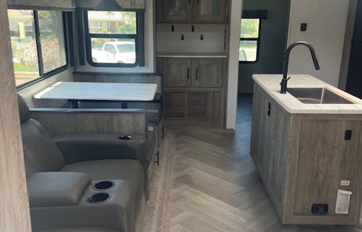 Comfortable kitchen, dining, living area with TV.