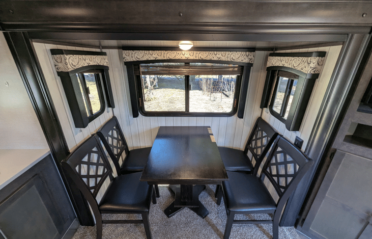 Very spacious living area offers a cozy retreat with theater-style recliners, a premium entertainment system, fireplace, TV, dinette and well-equipped kitchen.