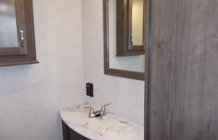 Bathroom sink with mirror and cabinet