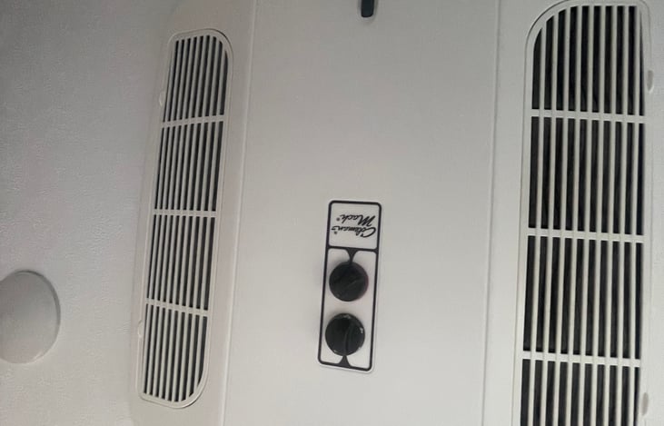 Ceiling mounted A/C, not much to look at, it keeps place cool.