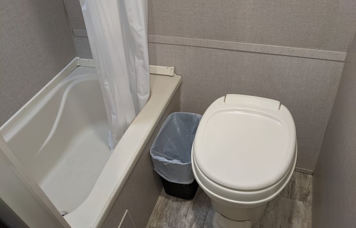 Shower with small tub. RV toilet. 5 towels provided.