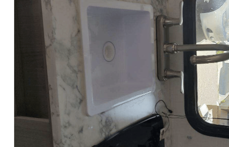 Kitchen sink... sideways for reasons unknown, it is upright in the unit.