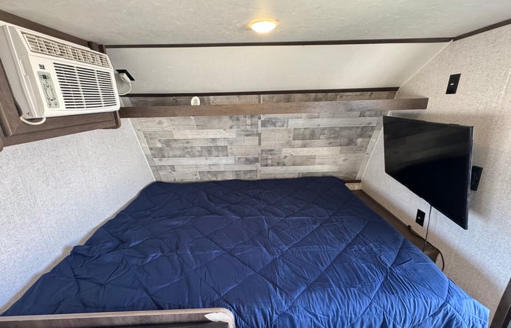 The queen size bed features a memory foam mattress which is very comfortable. The AC is near the bed to provide a cool sleeping environment during our hot summer months. A smart TV is mounted.