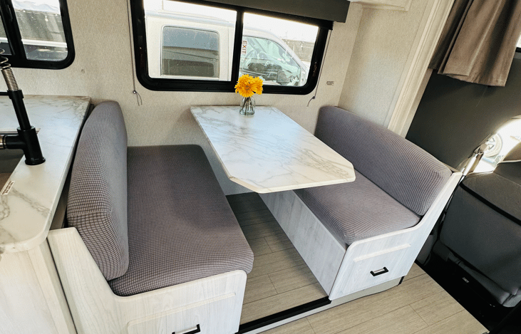 Dinette that converts to a bed to sleep 1-2. 
Extra long cabinets below and lots of storage above. 
Two seat belts and one for a child seat