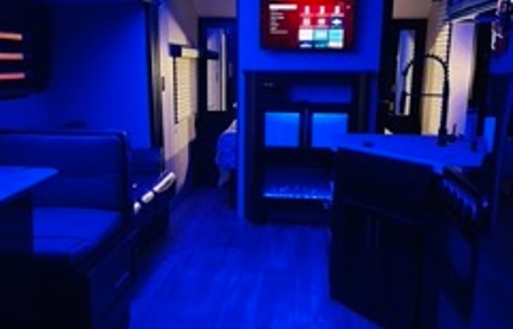 Table area comfortably sits 6 and converts into bed for 2. Sofa also converts into bed for 2.