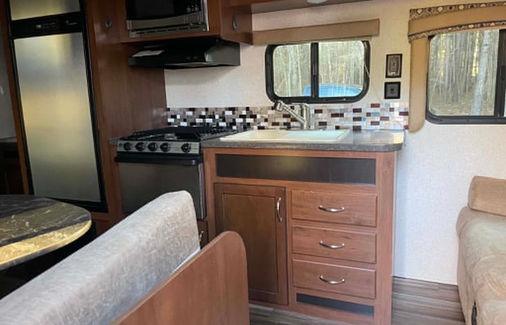 Propane stove, Microwave, Sink and cabnits filled with all the essentials.
