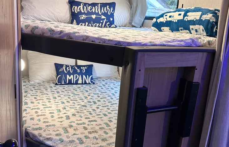 2 full size bunks with each having a charging station and black out curtains