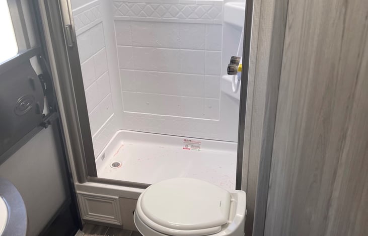 Bathroom & Shower with separate entrance/exit.  Allowing you to avoid walking through the whole RV if you just need to use the bathroom while outdoors.