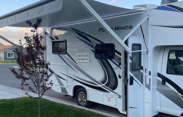 Awning extended with awning LED lights on. Passenger's side.