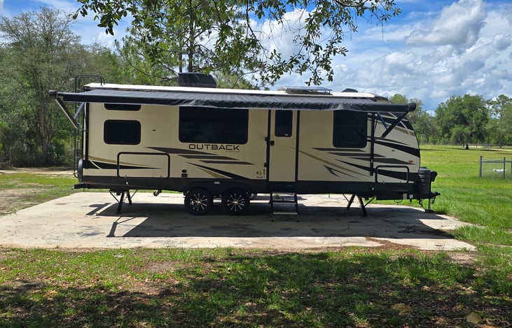 Electric awning with outside lights with eletric stability jacks. Outdoor cook stove and mini fridge