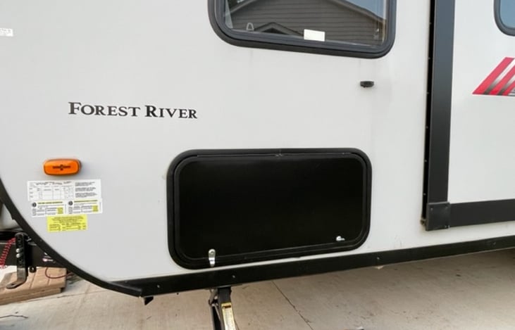 Forward baggage door left front of the camper.