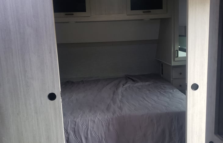 King side memory foam bed with dual sliding privacy barn doors