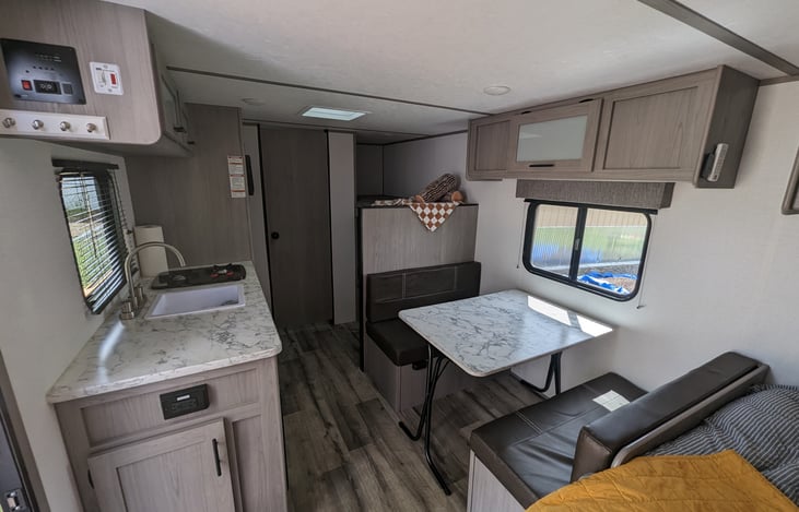Table is not fixed to the floor so it can be collapsed and stowed away or used outside the camper,  or convert the dinette space into another sleeping location.