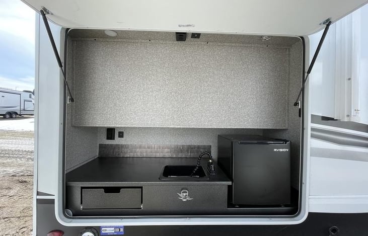 Outdoor Fridge and sink with area to plug in the griddle