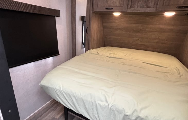 Queen bed with thick memory foam mattress pad and pillow top mattress protector for added comfort.