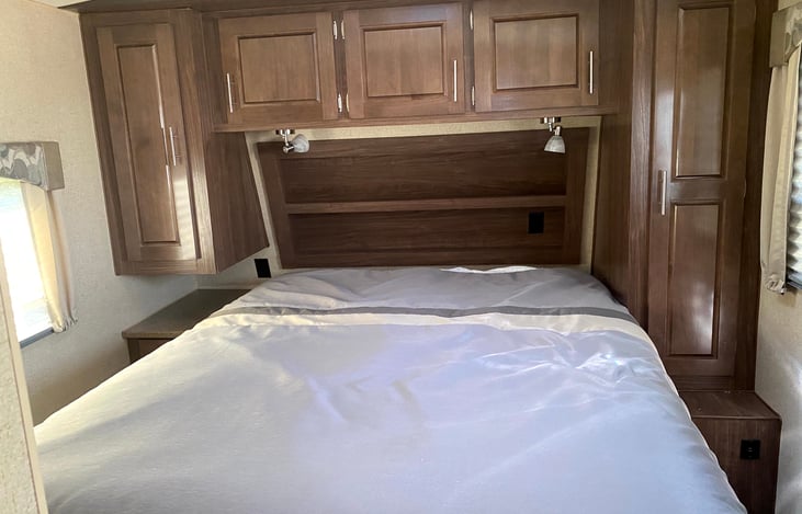 Queen bed with lots of storage around the bed