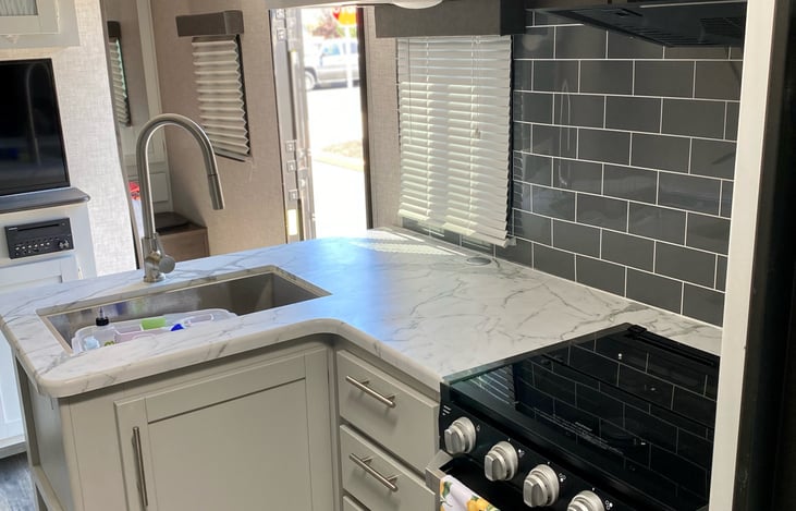 Fully stocked kitchen with microwave, stove, and oven. Gorgeous colors with easy to wipe surfaces all around.